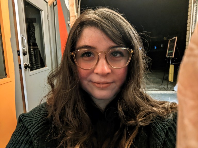 Woman with brown hair and glasses